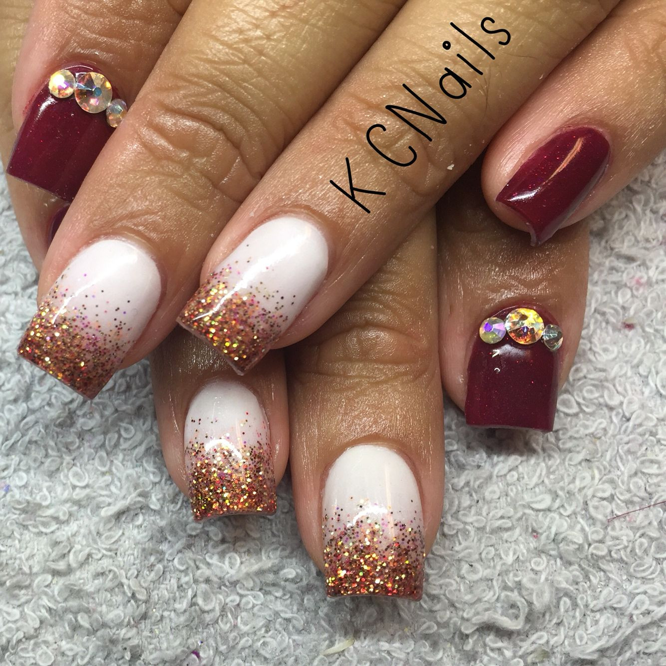 Maroon Nails With Glitter
 Maroon burgundy and white acrylic nails with fall glitter