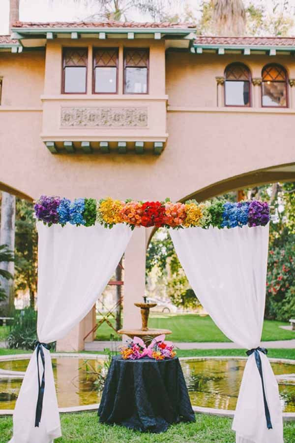 Rainbow Wedding Decorations
 Pixies Petals flower arch with flowers the color of the