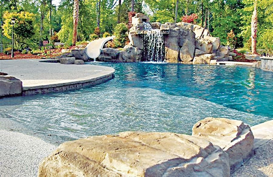 Backyard Beach Pool
 Zero beach entry swimming pool with large rock waterfall