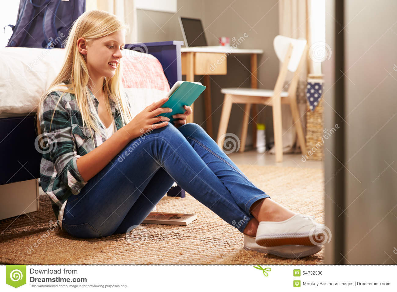 Girl In The Bedroom
 Girl Using Digital Tablet In Her Bedroom Stock