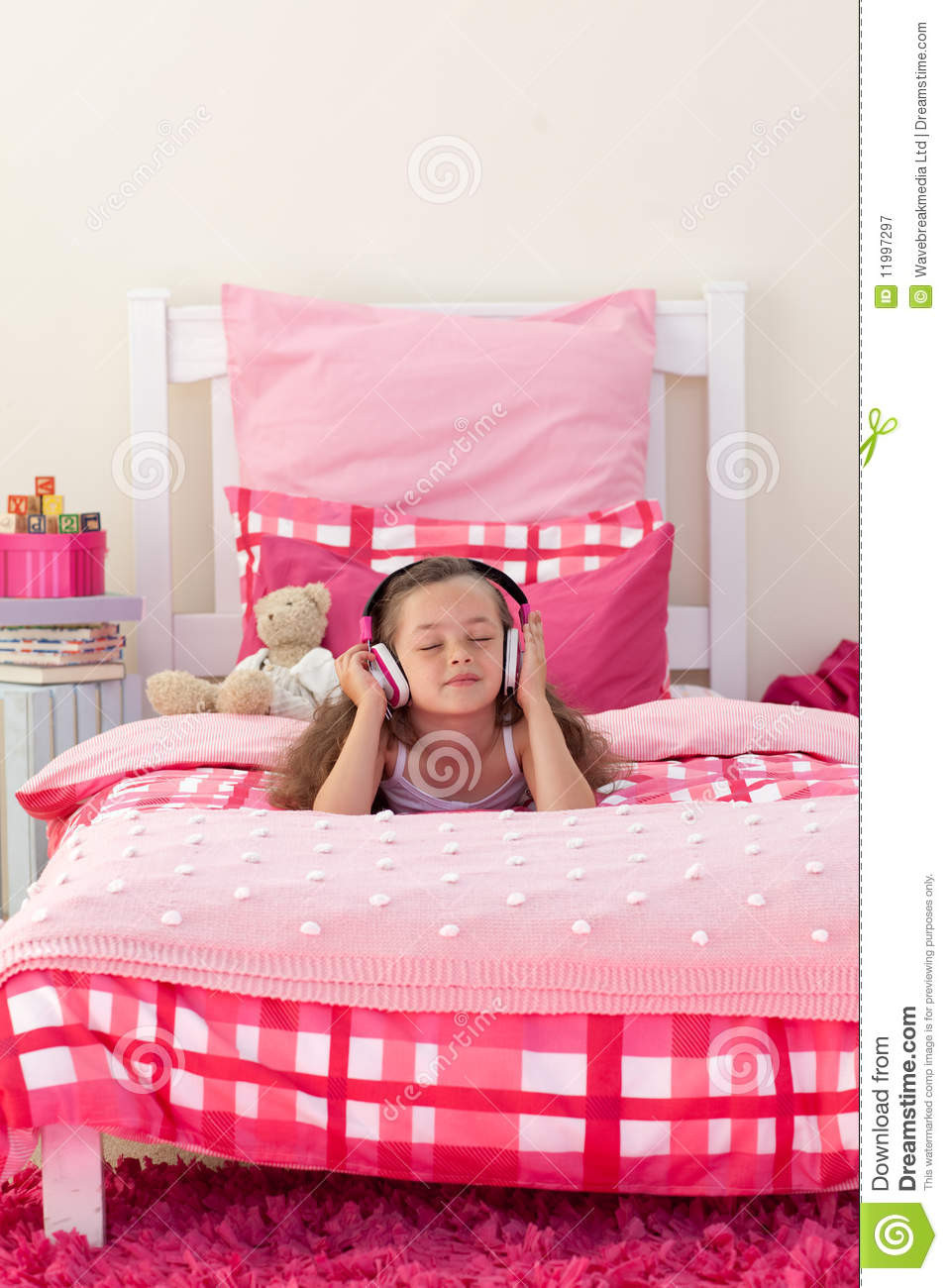 Girl In The Bedroom
 Little Girl Listening Music With Headphones Stock Image